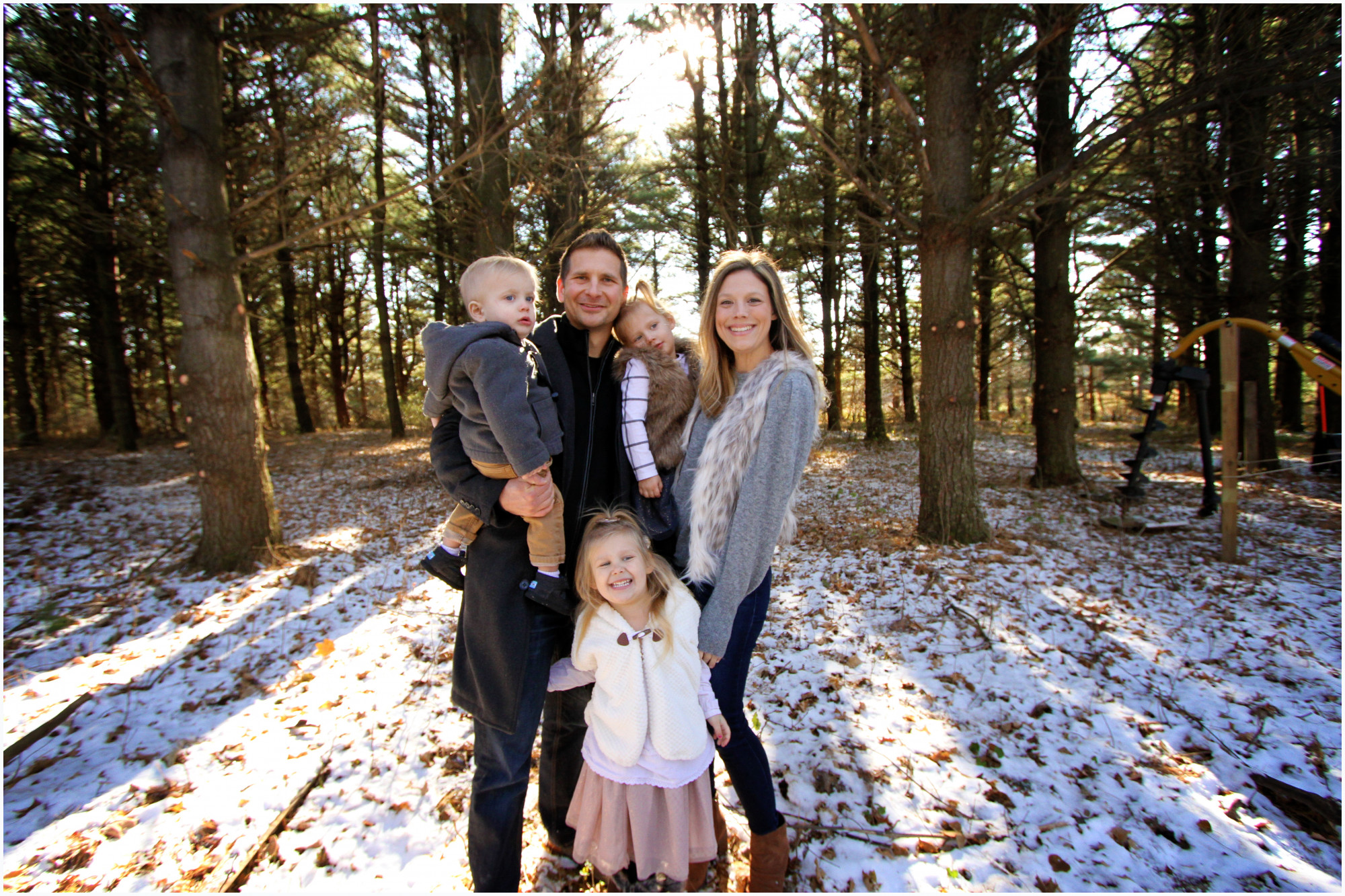 family photo in the woods with snow on ground