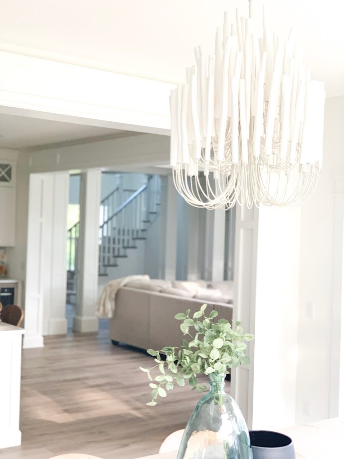 Large chandelier in dining space overlooking great room 