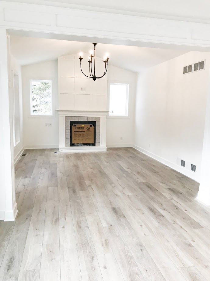 rod iron pottery barn chandelier in vaulted living room 