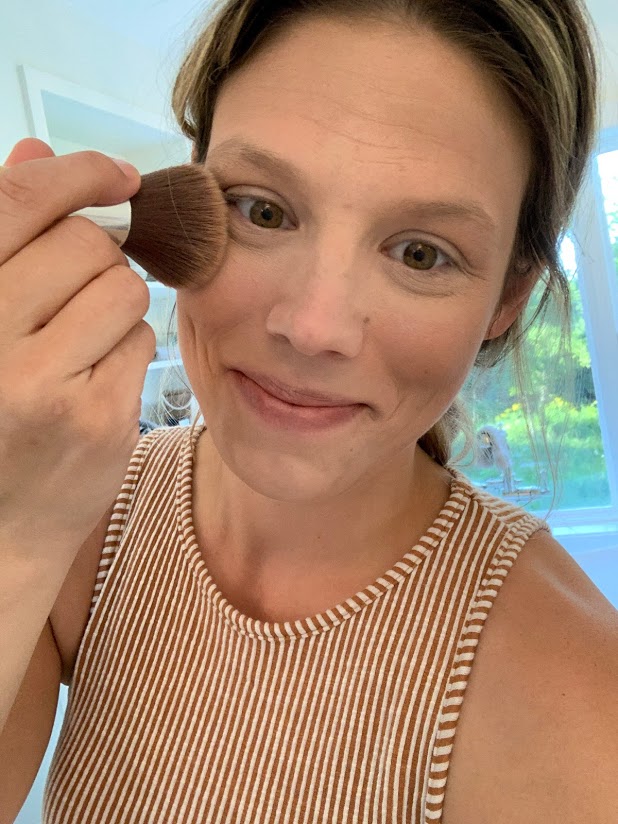 woman with bronzer brush