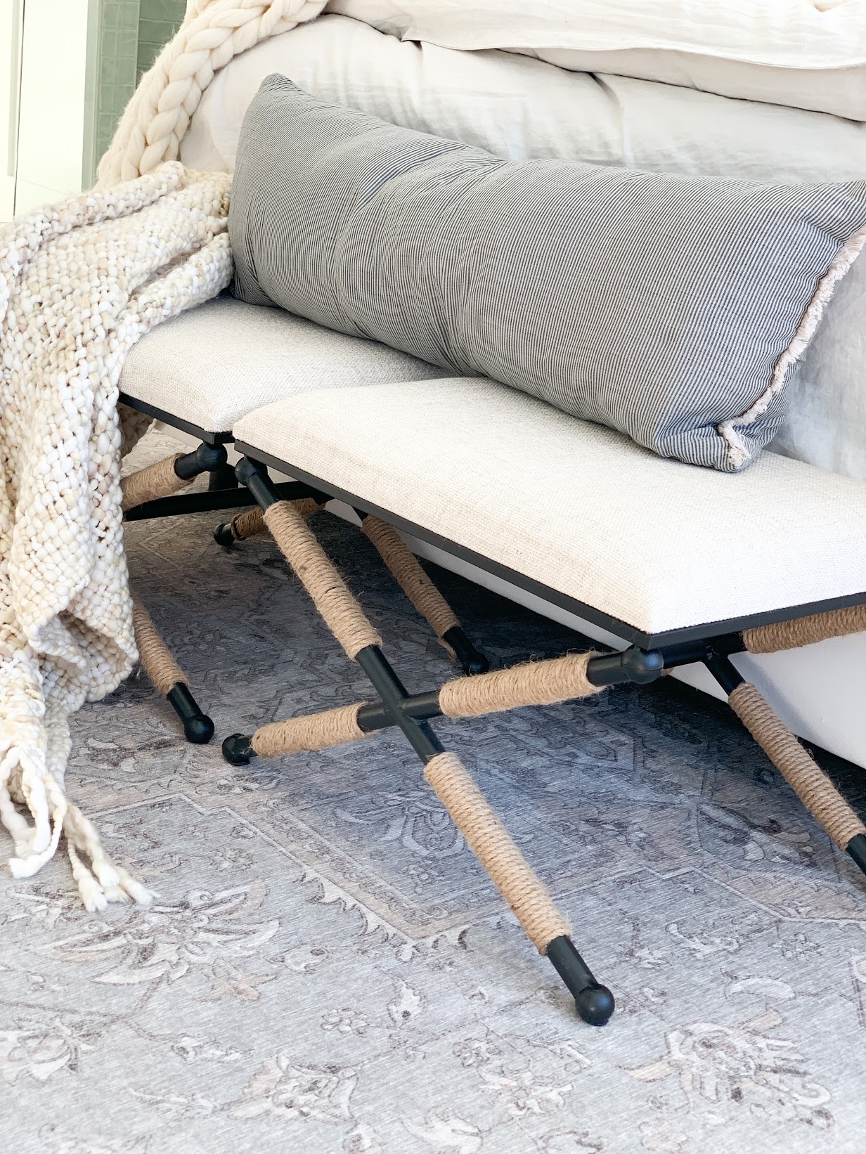 stools at end of bed with bolster pillow